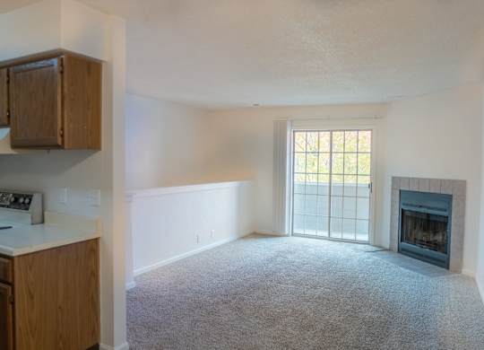 A living room with a fireplace and a window.