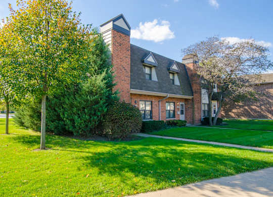 A house with a red brick exterior and a grey roof.
