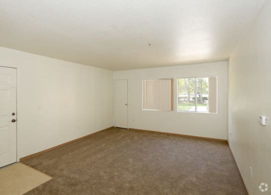 a bedroom with white walls and carpet