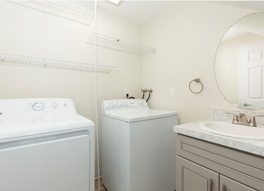 In-Unit Laundry Area with Vanity Sink, Cabinet, and Mirror at Woodlake Townhomes, Washington, 98026