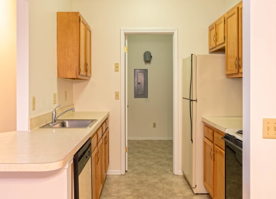 Kitchen With Attached Laundry Room At Blueberry Hill Apartments, Rochester, NY