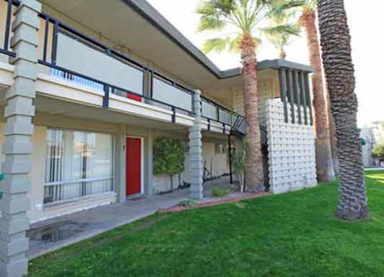 A house with a red door and a balcony.
