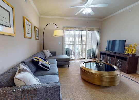 Living room couch at Lakeland Estates Apartments in Stafford TX