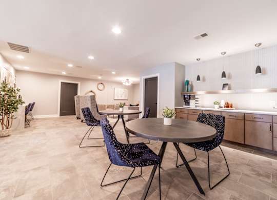 Tables and chairs in clubhouse at Governor Square Apartments, Indiana