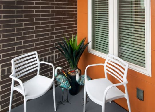 Thh Wilmore patio with two chairs and a plant