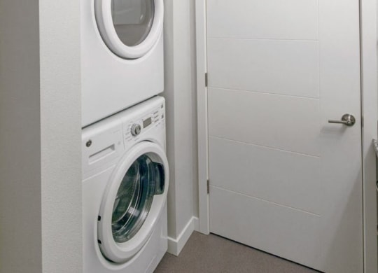 The Wilmore Laundry room with stacked washer and dryer