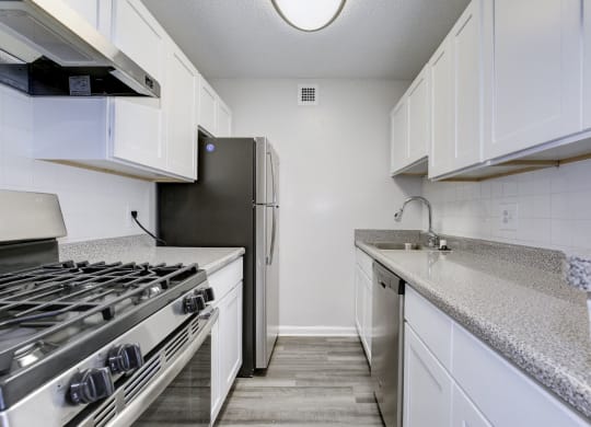a kitchen with white cabinets and stainless steel appliances at Avondale Overlook, Hyattsville, MD