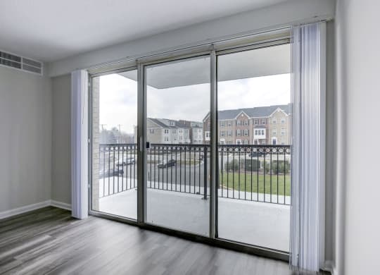 an open living room with sliding glass doors to a balcony at Avondale Overlook, Hyattsville