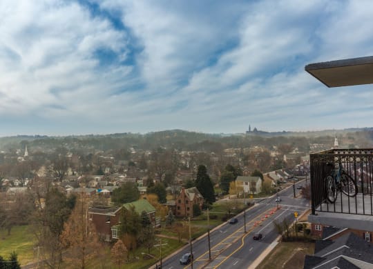 the view of the city from the balcony of a building with a bike at Avondale Overlook, Maryland