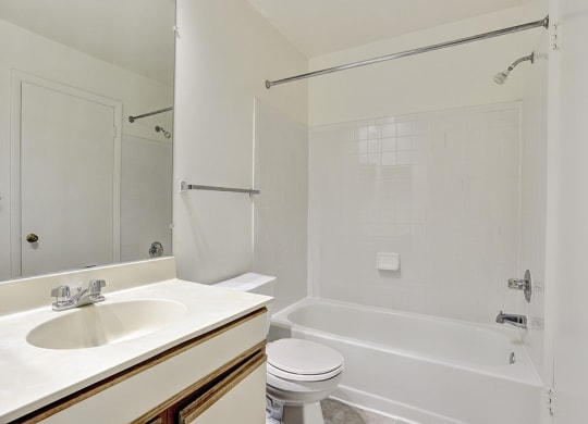 a bathroom with a sink toilet and a tub