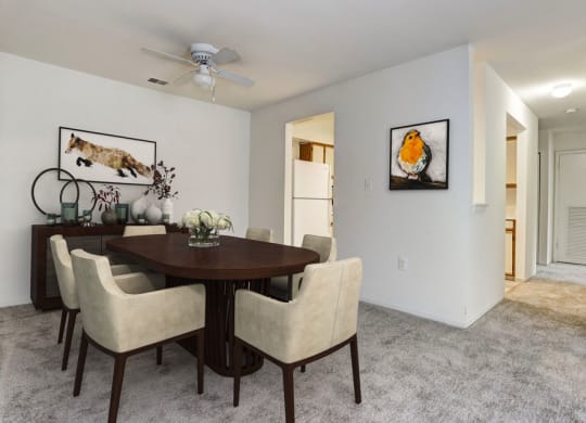 a dining room with a table and chairs and a ceiling fan