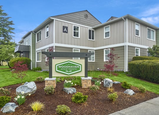 Exterior view of building and front sign with well maintained landscaping. at Woodhaven, Everett, WA