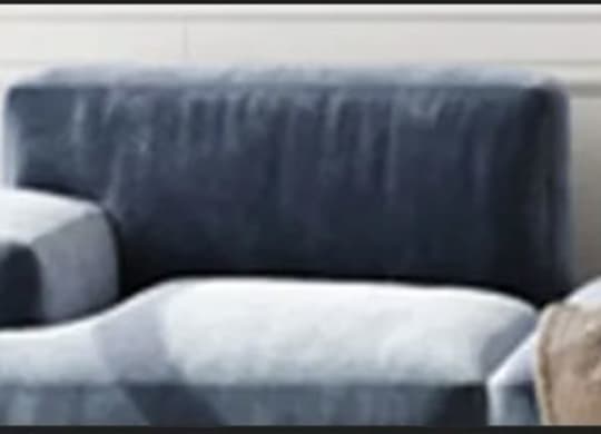 a blue chair sitting next to a white wall