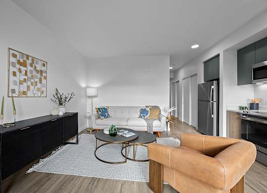 A modern living room with a brown leather sofa and a white couch.