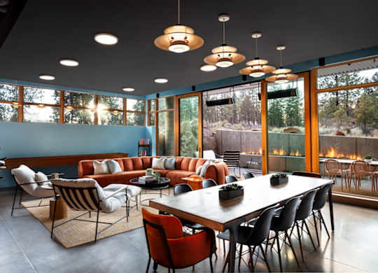 A modern dining room with a large table and chairs.