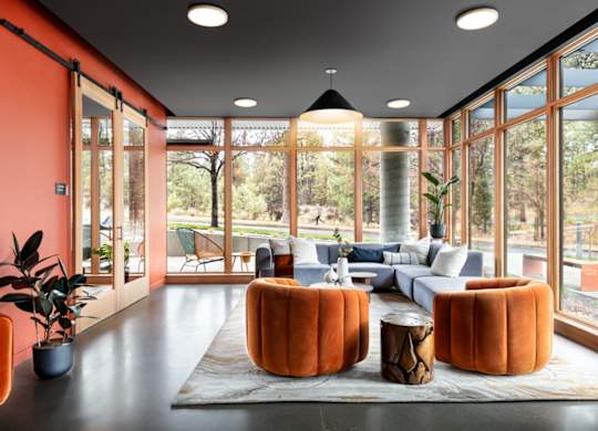 A living room with orange walls and furniture.