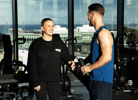 A man and a woman in a gym, the woman is wearing a black Nike sweatshirt and the man is wearing a blue sleeveless shirt. at Cherrywood Apartments, D18 VY3V, DUBLIN 18