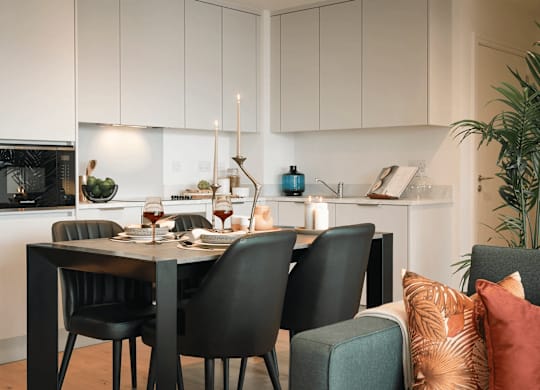 A modern kitchen with a dining table set for two. at Cherrywood Apartments, D18 VY3V, DUBLIN 18