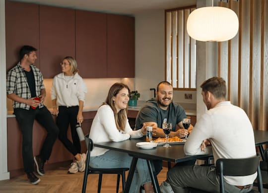 A group of people are gathered around a table eating and drinking. at Cherrywood Apartments, D18 VY3V, DUBLIN 18