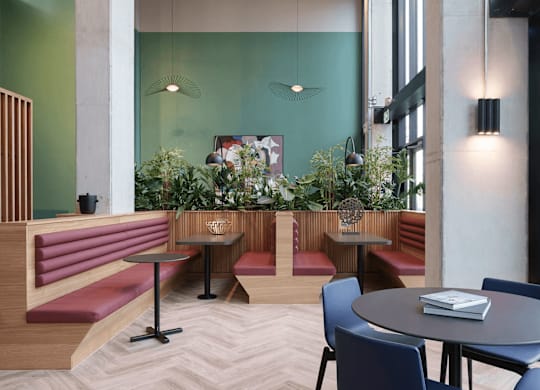 A restaurant with tables and chairs and a green wall. at Cherrywood Apartments, D18 VY3V