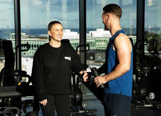 A man and a woman in a gym, the woman is wearing a black Nike sweatshirt and the man is wearing a blue sleeveless shirt at Cherrywood Apartments, D18 VY3V, DUBLIN 18