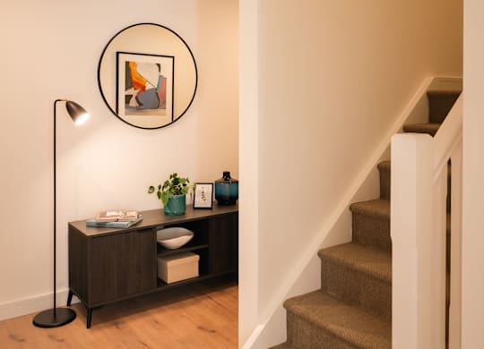 A staircase with a light brown carpet and a white railing at Cherrywood Apartments, D18 VY3V, DUBLIN 18