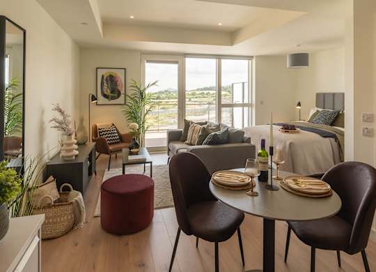 A modern dining room with a round table and chairs at Cherrywood Apartments, D18 VY3V, DUBLIN 18