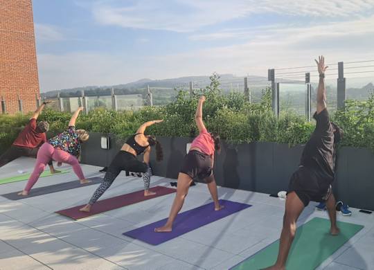 A group of people practicing yoga on a rooftop at Cherrywood Apartments, D18 VY3V, DUBLIN 18