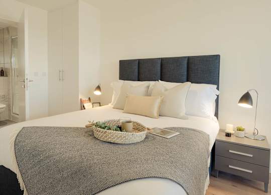 A bedroom with a large bed and a basket on the bed at Cherrywood Apartments, D18 VY3V, DUBLIN 18