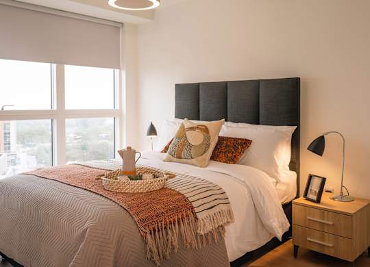 A bedroom with a large bed and a window overlooking a cityscape at Cherrywood Apartments, D18 VY3V, DUBLIN 18