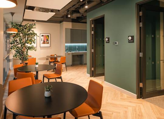 A conference room with a round table and orange chairs at Cherrywood Apartments, D18 VY3V, DUBLIN 18