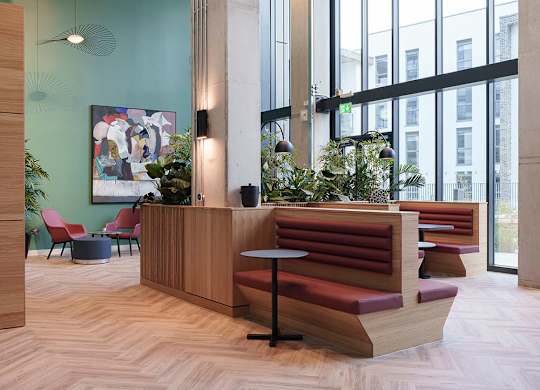 A reception area with a wooden bench and a green wall at Cherrywood Apartments, D18 VY3V