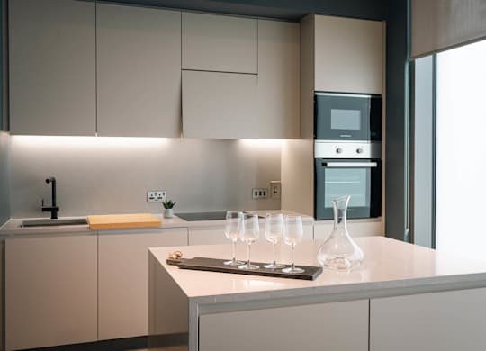 A modern kitchen with a sink, a counter, and a microwave at Cherrywood Apartments, D18 VY3V