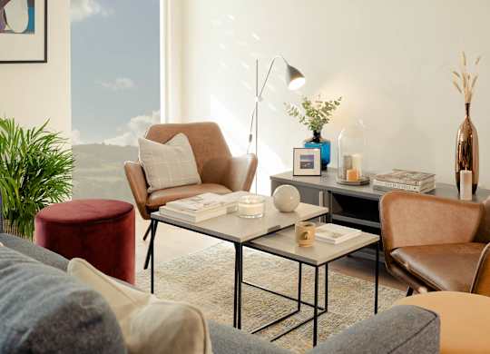 A living room with a large window, a sofa, a chair, a coffee table, and a lamp at Cherrywood Apartments, D18 VY3V