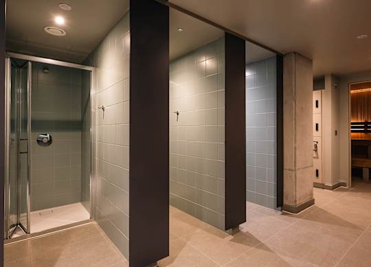 A bathroom with a glass shower stall and a bench at Cherrywood Apartments, D18 VY3V, DUBLIN 18