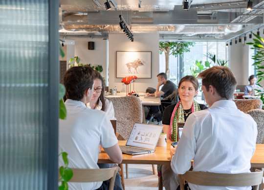 Group of people sitting around table in modern office at The Lark, London, SW11 7EA