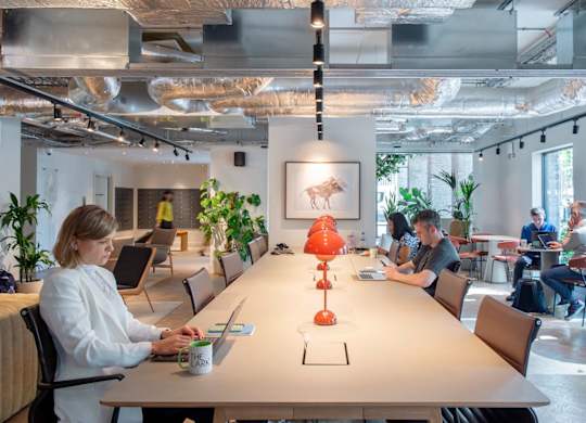 Co-working space with a long table and chairs at The Lark, London, SW11 7EA