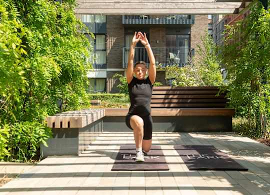 Woman exercising in garden area at The Lark, London, SW11 7EA