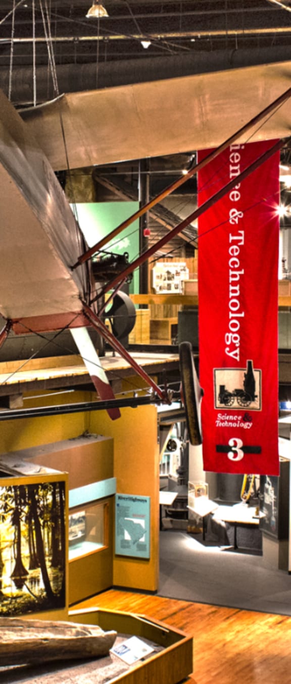 an airplane hanging from the ceiling in a museum at Carrington Place at Wildewood, Columbia
