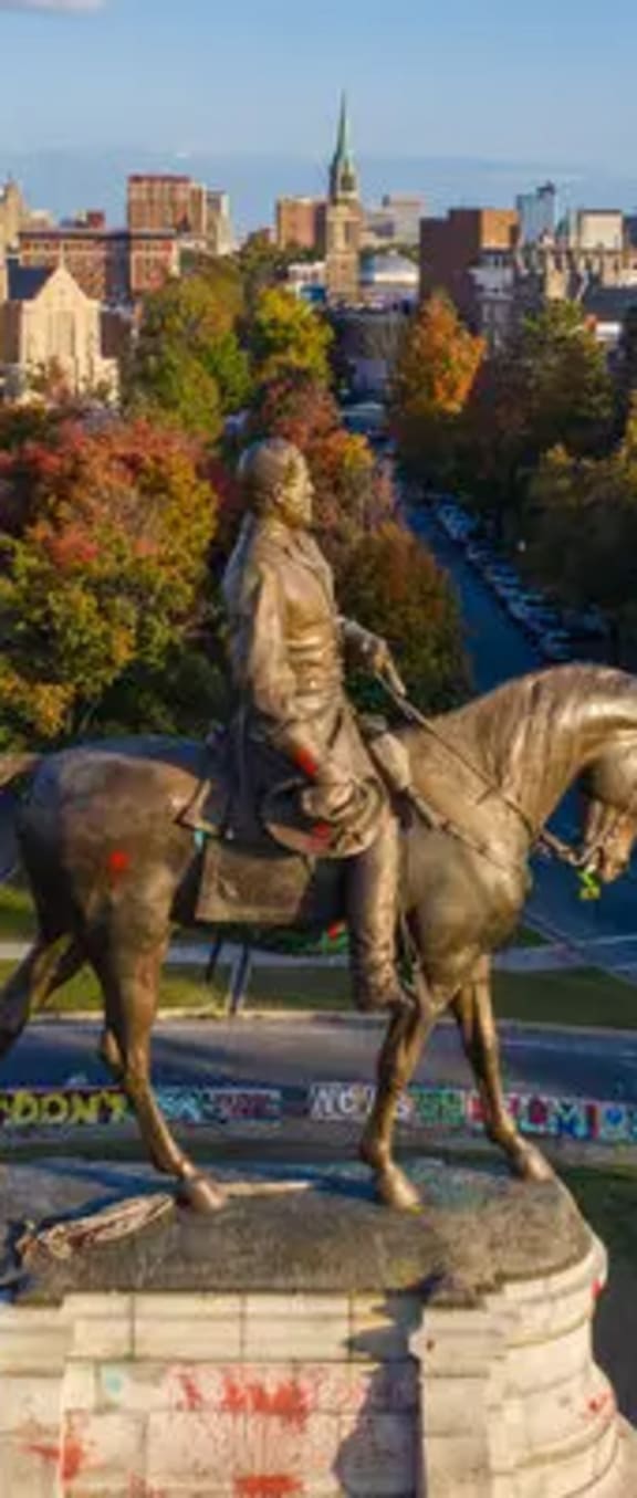 a statue of a man riding a horse in a park