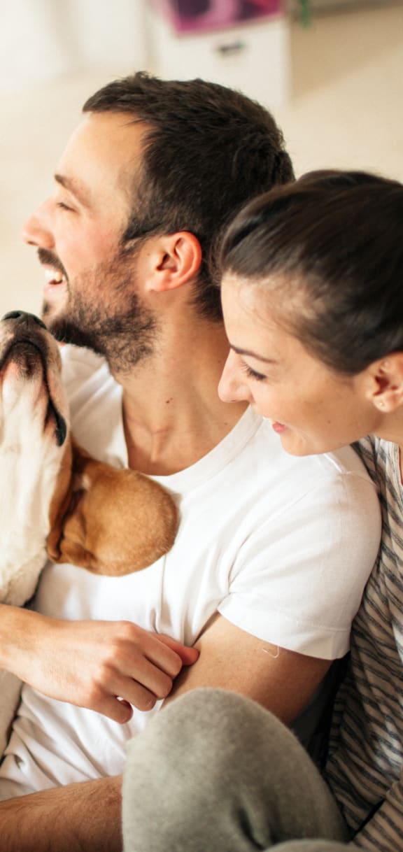 a woman holding a dog in her arms