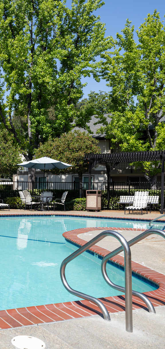 Green bench in front of playground, Clayton Creek Apartments, Concord, California, 94521