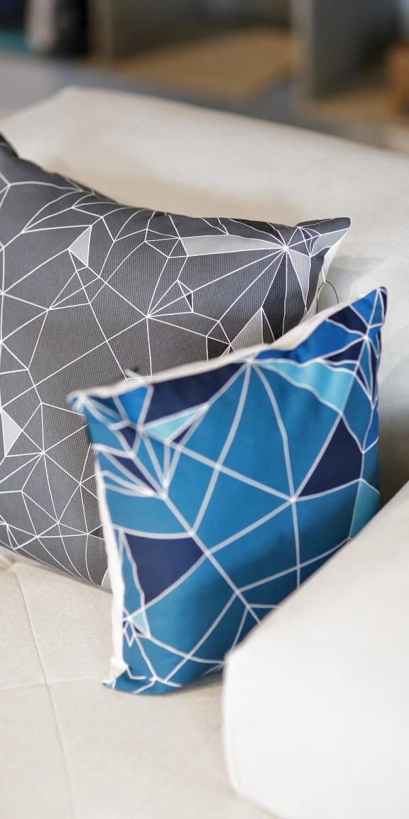 a group of pillows sitting on top of a couch