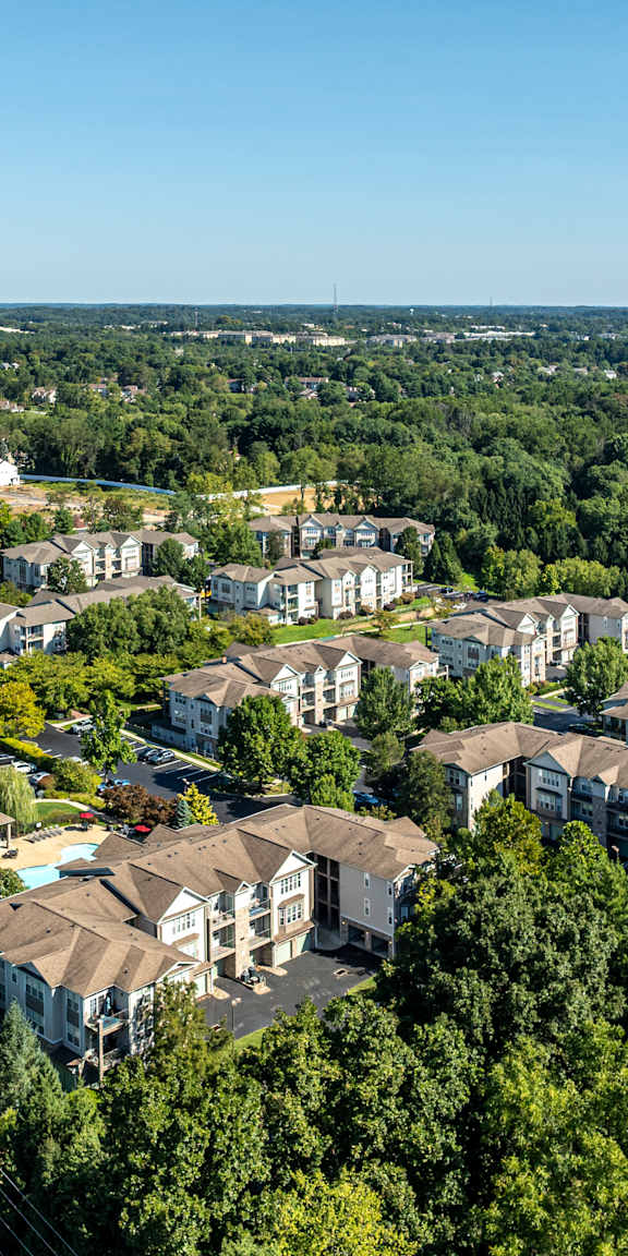 A bird's eye view of a residential area with houses and a road.