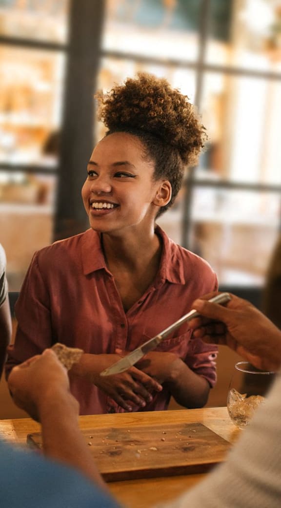 a group of people sitting at a table talking