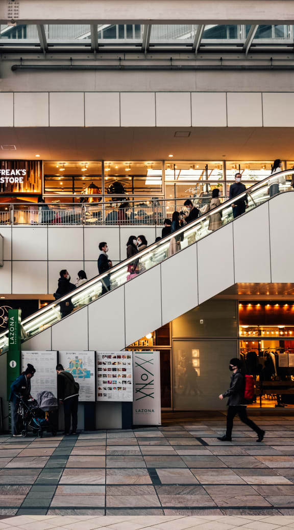 people on an escalator in a shopping mall