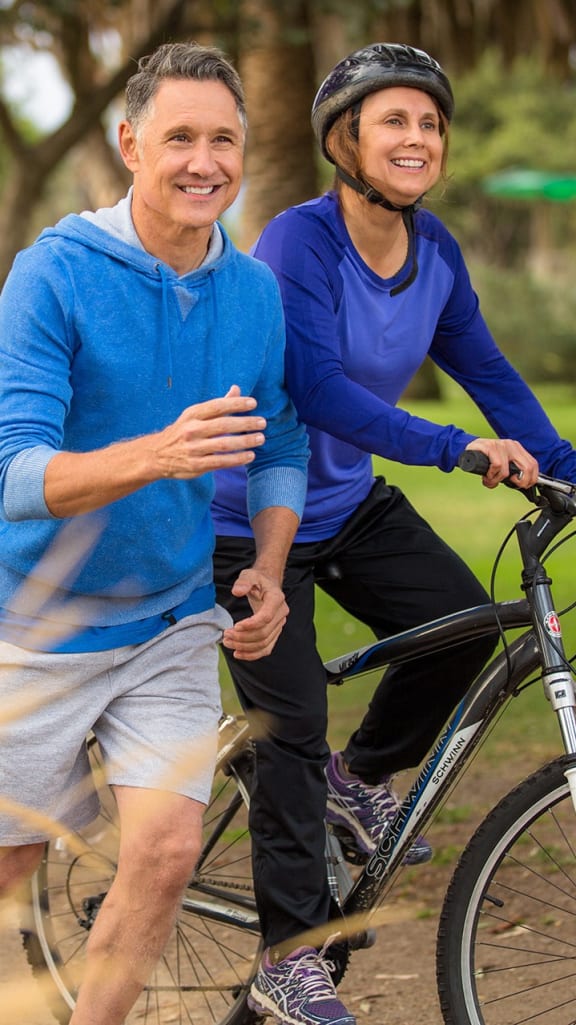 two men on a bike in a park