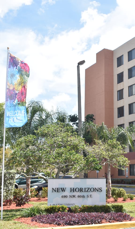 a building with a sign that says new horizons in front of it