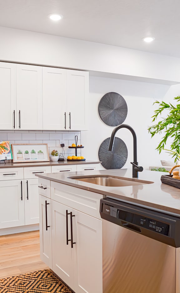 A kitchen with a white countertop and brown cabinets.
