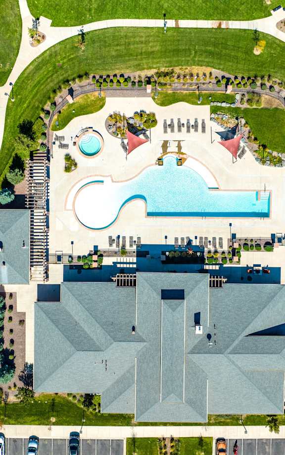 A large building with a pool in front of it.